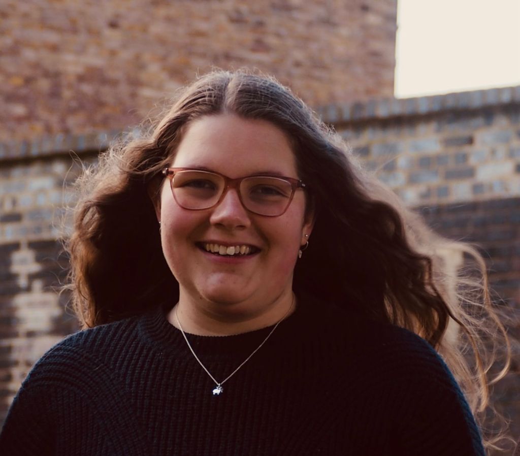 Photo of Anna in front of brick background
